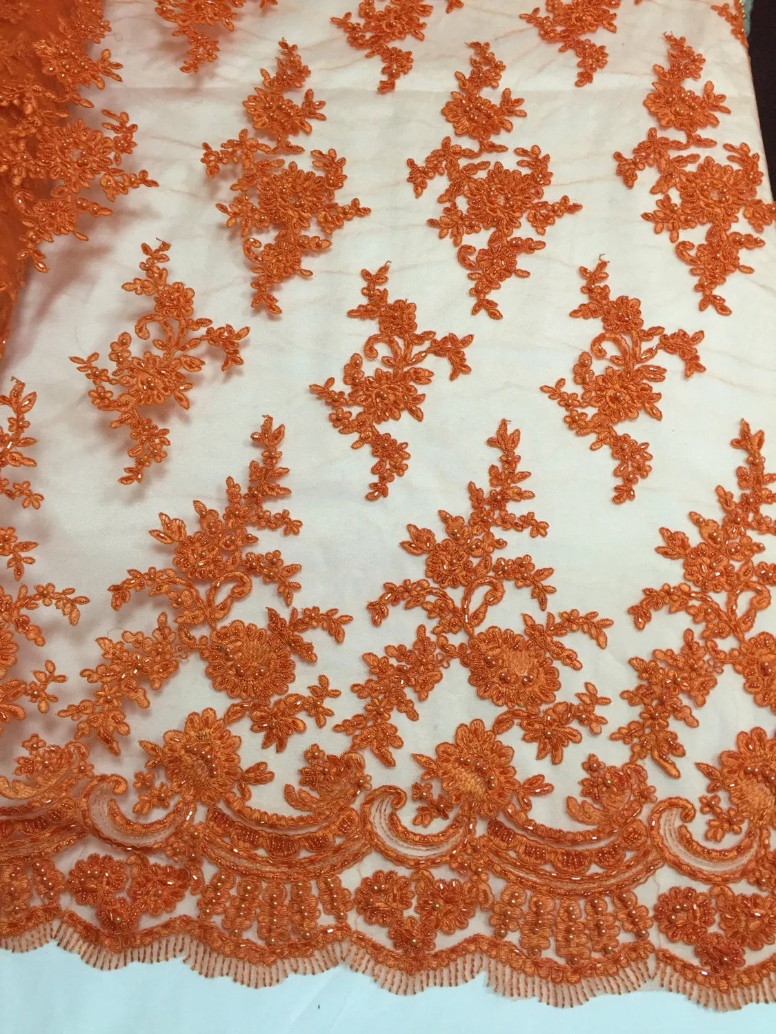Orange appealing flower design embroider and beaded on a mesh lace-yard