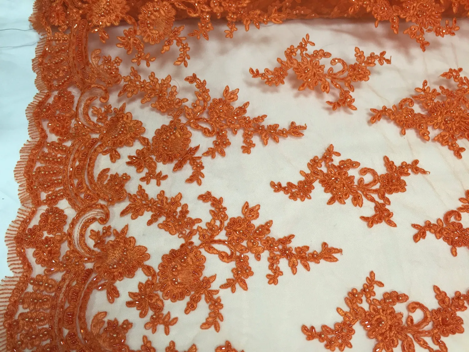 Orange appealing flower design embroider and beaded on a mesh lace-yard